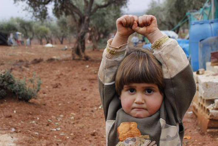 Syrian Girl Hands up in front of Camera for Gun in Heartbreaking Photo