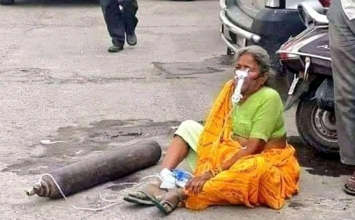 Woman with Oxygen Cylinder on the Road in India