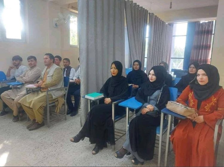 Men & women during lecture in classroom in Afghanistan of Taliban